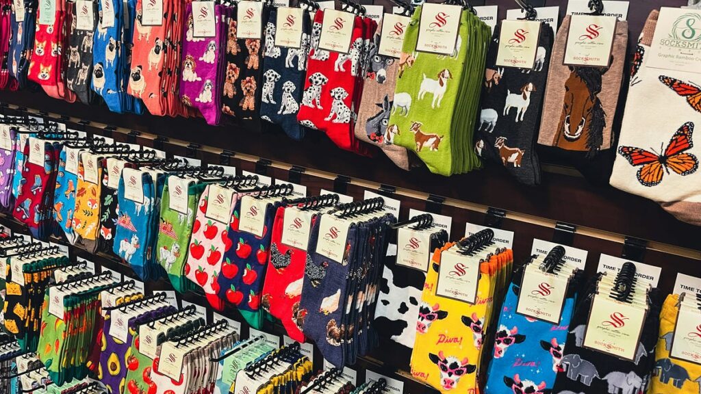 A colorful selection of different patterned socks on the shelf in a store