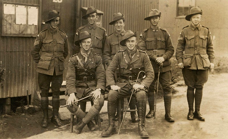 A platoon of ANZAC soldiers in front of a tin barrack