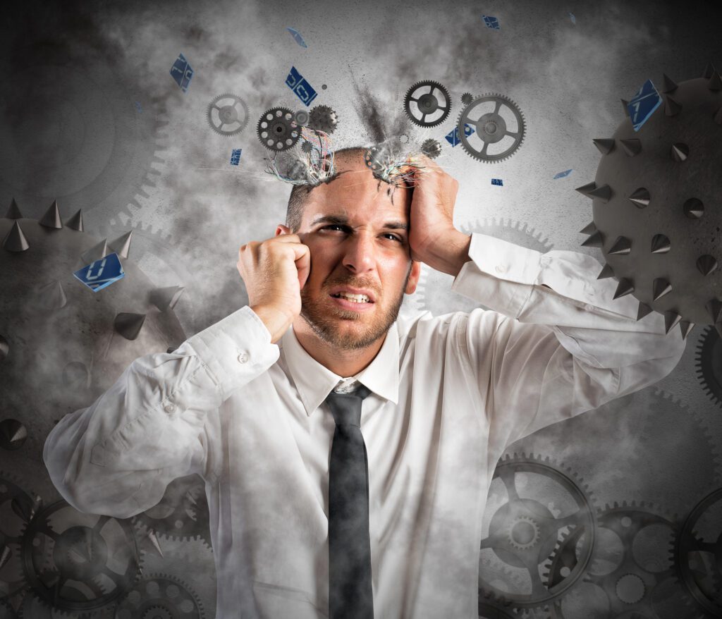 A man holding hid head with all sorts of question marks and exclamation marks floating around
